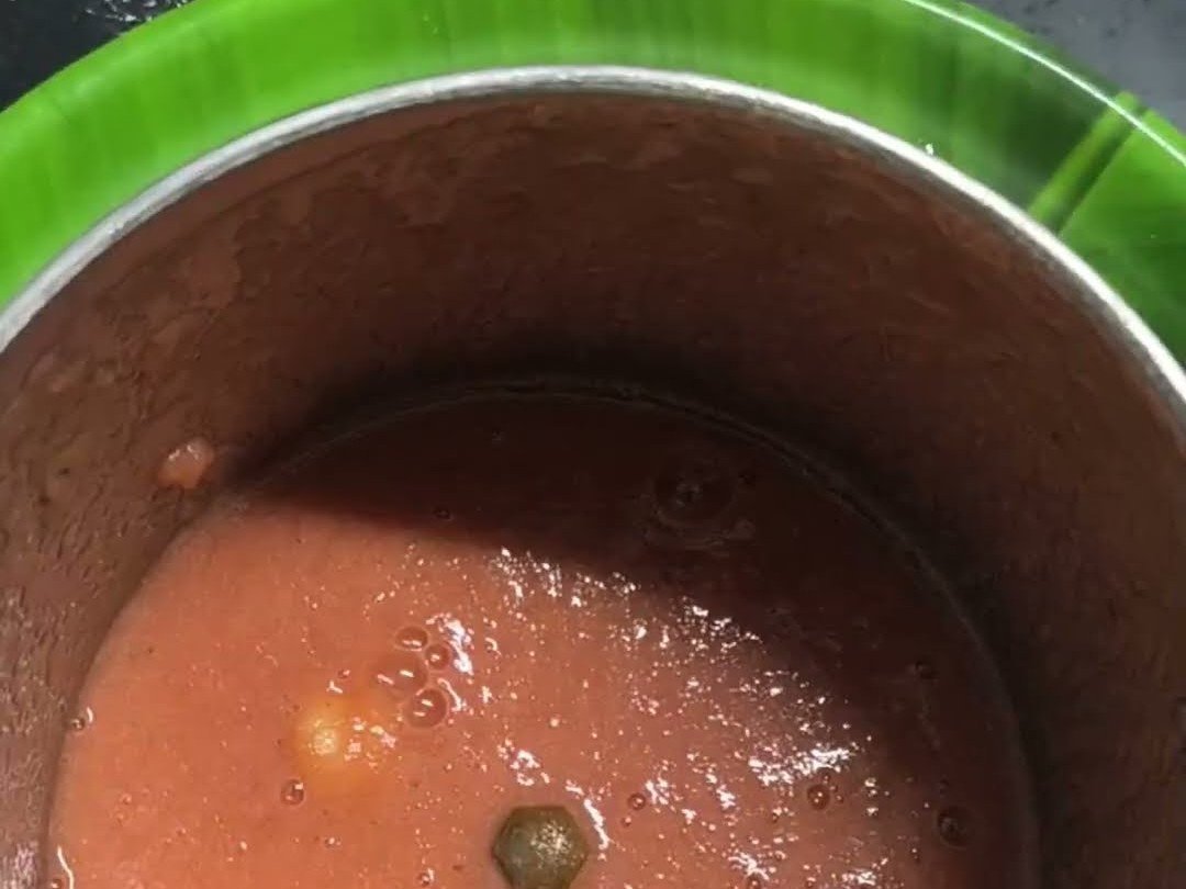 Smooth red tomato onion chutney ground in a mixer jar